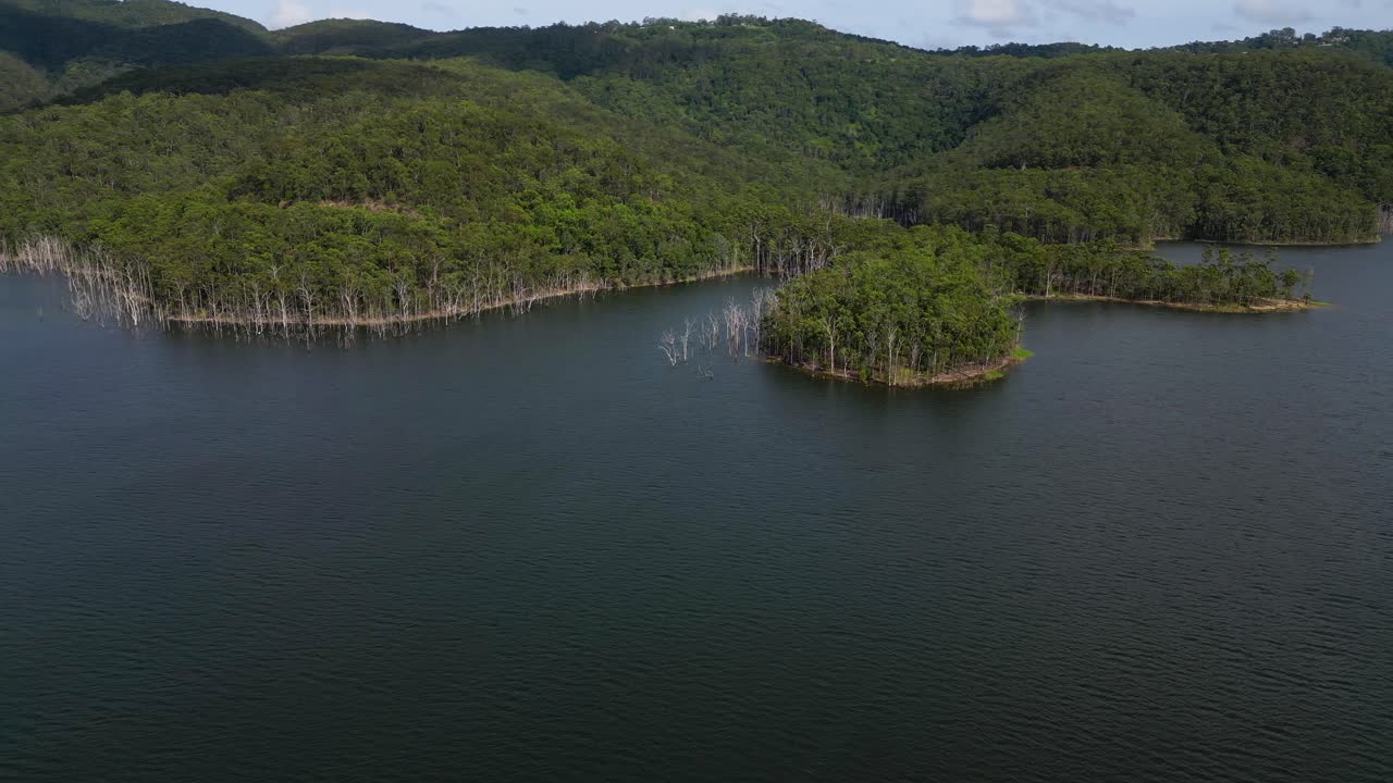 Right to left aerial views of Advancetown Lake near the Western Boat Ramp on the Gold Coast Hinterland.
