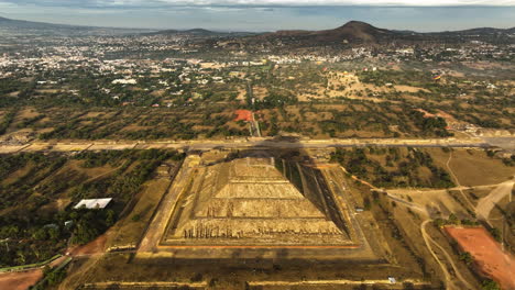 drone descending toward the pyramid of the sun, sunrise in teotihuacan, mexico