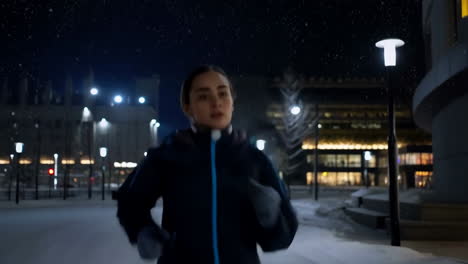 woman running in a snowy city at night