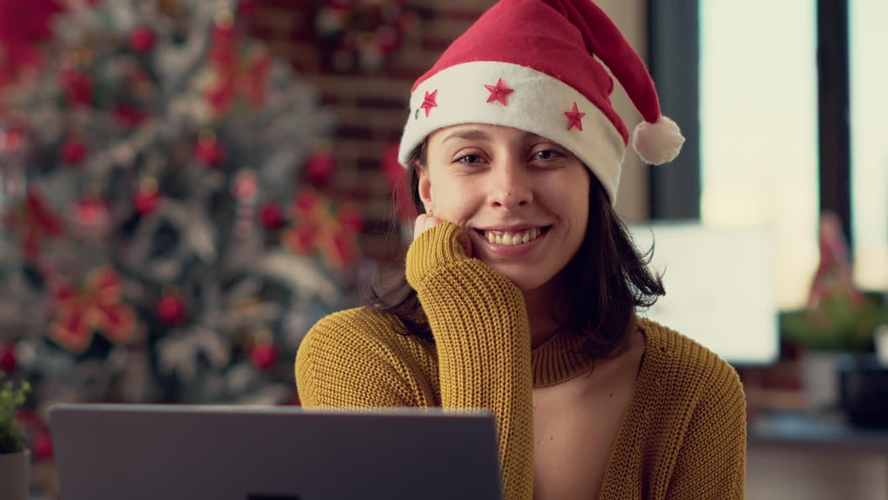 Portrait of office worker wearing santa hat during winter holiday