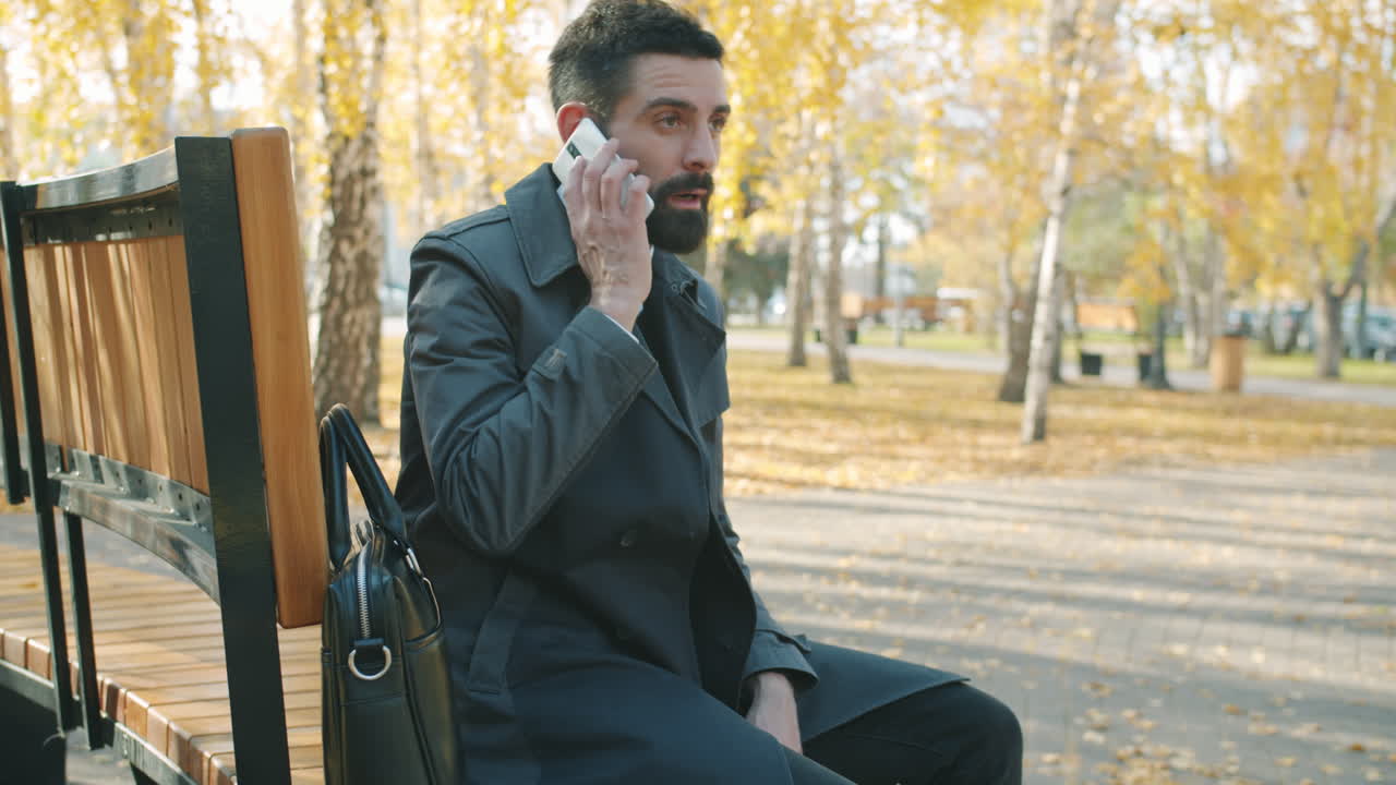 Businessman Talking on Phone in Park