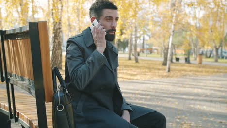 businessman talking on phone in park