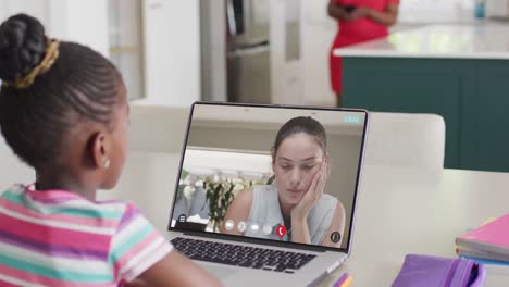 Diverse-schoolgirl-having-laptop-video-call-with-female-student-in-slow-motion