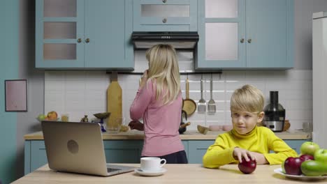 mother working from home while child eats breakfast