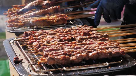 pork meat skewer on fire, mutton barbecue close-up. fried meat for kebab. cooking grilled meat beef chicken lamb bbq . kebab on grill. chinese street local market with traditional food. asian fast food.