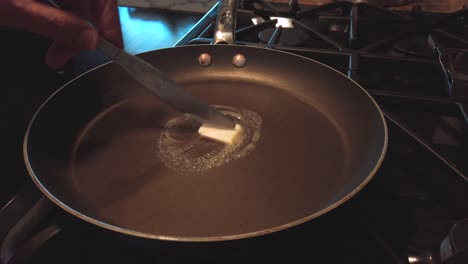 static shot, melting butter in pan, in kitchen