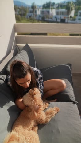 woman and her poodle on a patio