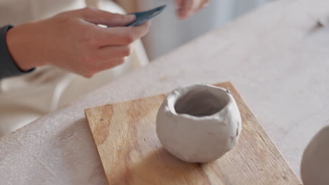 woman making a clay pot