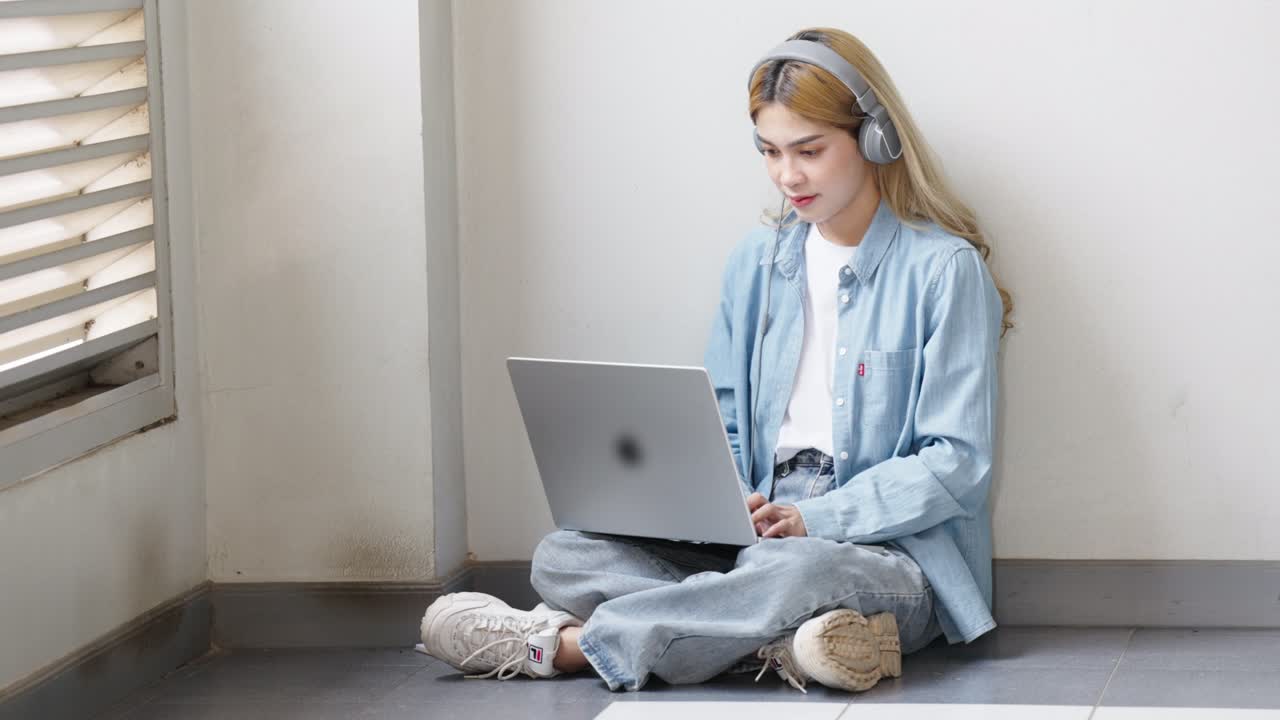 Two Asian girls student partners are working on a laptop help study together