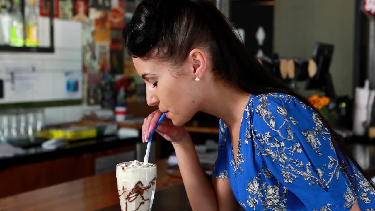 Donna felice che beve un milkshake