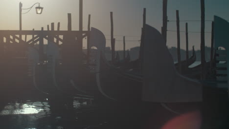 covered gondola boats at sunset