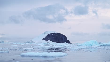 Sunset-Winter-Mountains-and-Ocean-in-Antarctica-with-Dramatic-Clouds-and-Sky,-Amazing-Scenery-on-Antarctic-Peninsula-Coast,-Sunset-Coastal-Scenery-in-Icy-Snowy-Scene-in-Cold-Weather