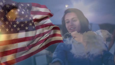 Animation-of-waving-usa-flag-over-group-of-friend-on-the-beach