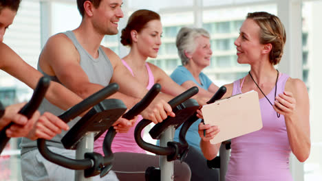 happy group doing a spinning class