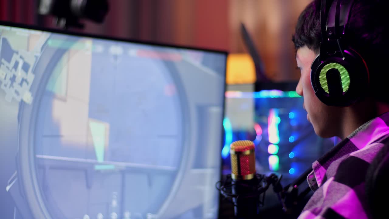 Close Up Back View Of Asian Boy Streamer Playing Game Over Network On Personal Computer. Yawning And Sleeping, Live Stream Video Game, Desk Illuminated By Rgb Led Strip Light
