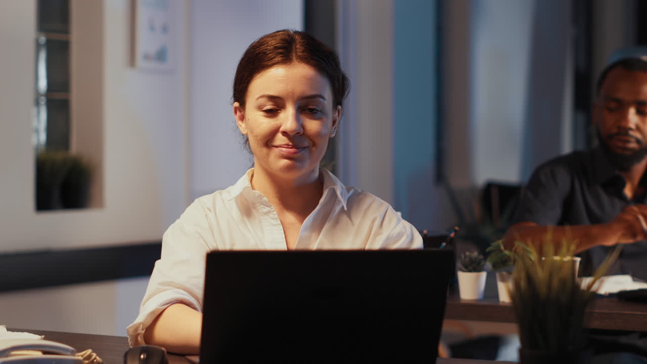 Portrait of female employee using laptop to plan startup report