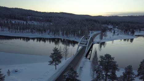 A-bridge-in-a-rural-frozen-landscape-of-Sweden,-during-winter