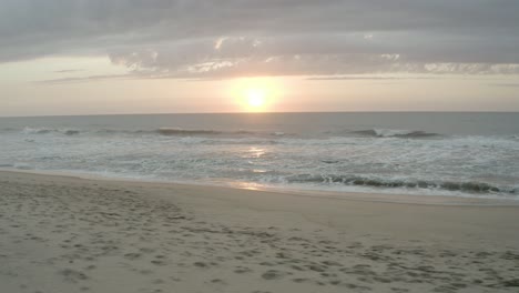 a sunset view of the sun while on the beach