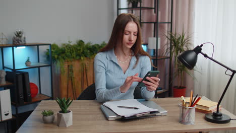 young woman freelancer working online remote distance job education sitting at desk at home office