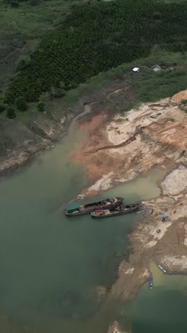 Aerial view of ships on a lake with eroded shoreline