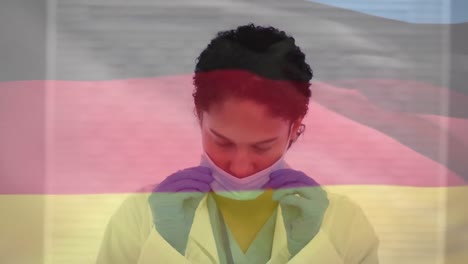 animación de la bandera de alemania sobre una doctora biracial con máscara facial