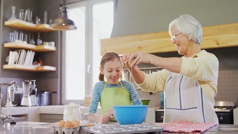 grandmother breaking an egg in bowl and little girl watching 4k 4k