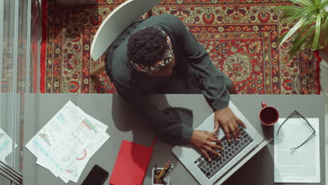 Top-Down-Portrait-of-African-American-Businesswoman-at-Office-Desk