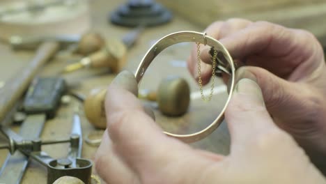 close ups of a craftsman making jewellery in a workshop