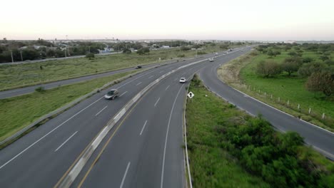 aerial - vert light traffic on a highway in reynosa, mexico, wide tracking shot