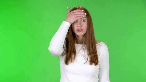 portrait of pretty young woman is upset and making facepalm