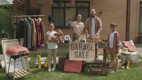 happy family having garage sale in summer