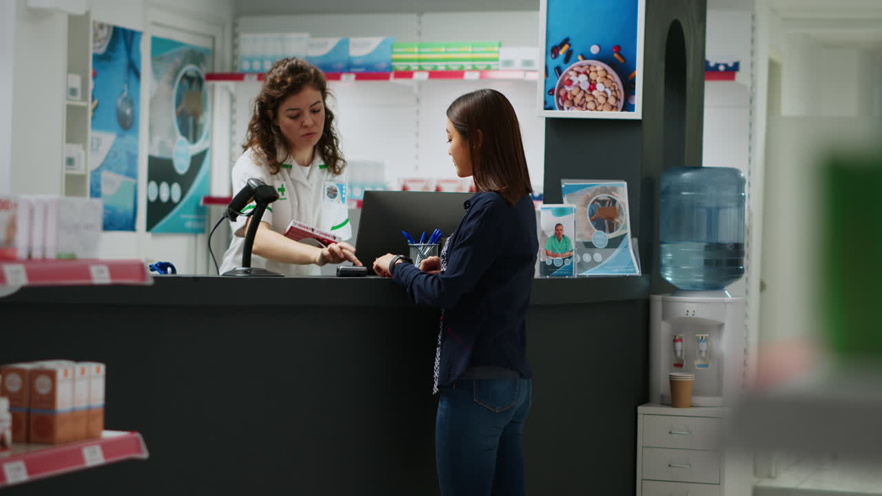 Pharmacist serving customer at pharmacy counter