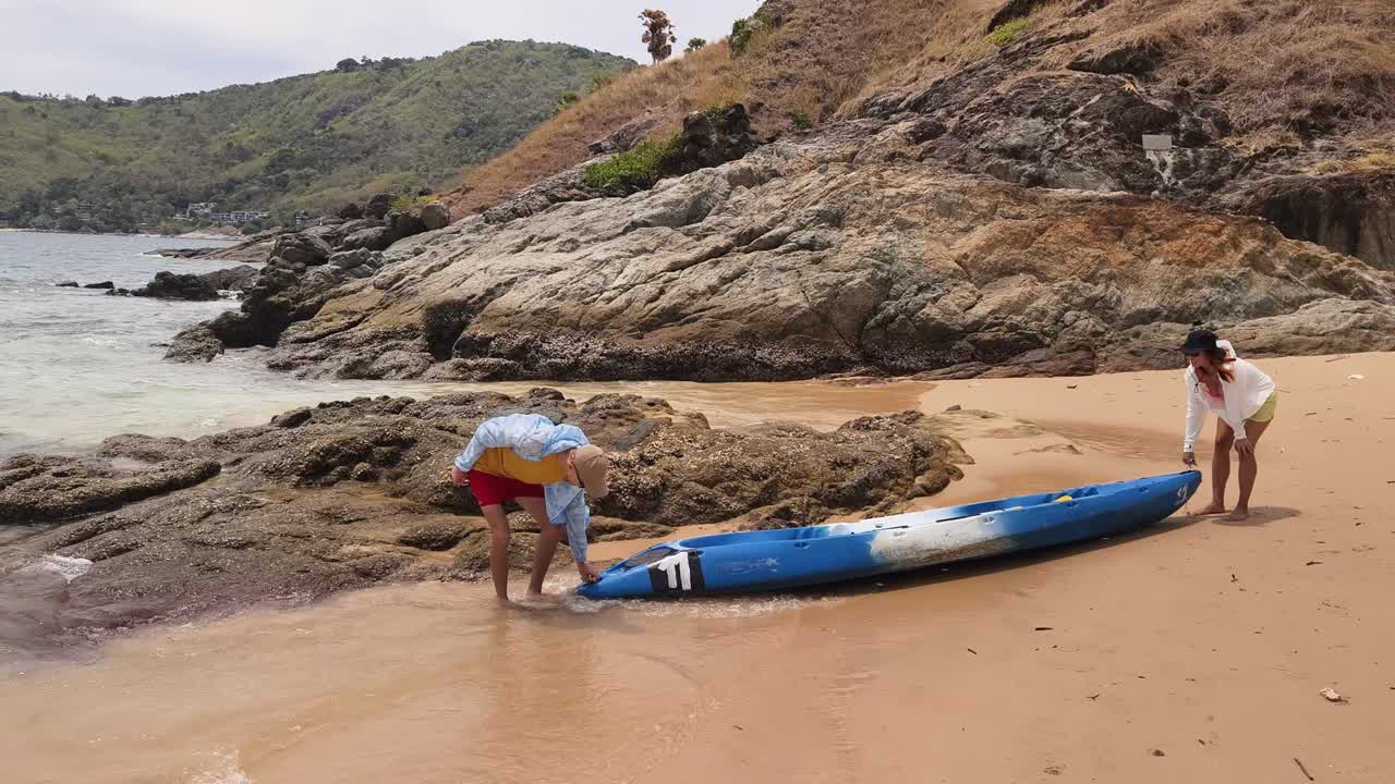 Couple Kayaking on a Tropical Beach