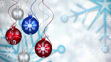 animación de bolas de navidad sobre copos de nieve que caen sobre un fondo blanco