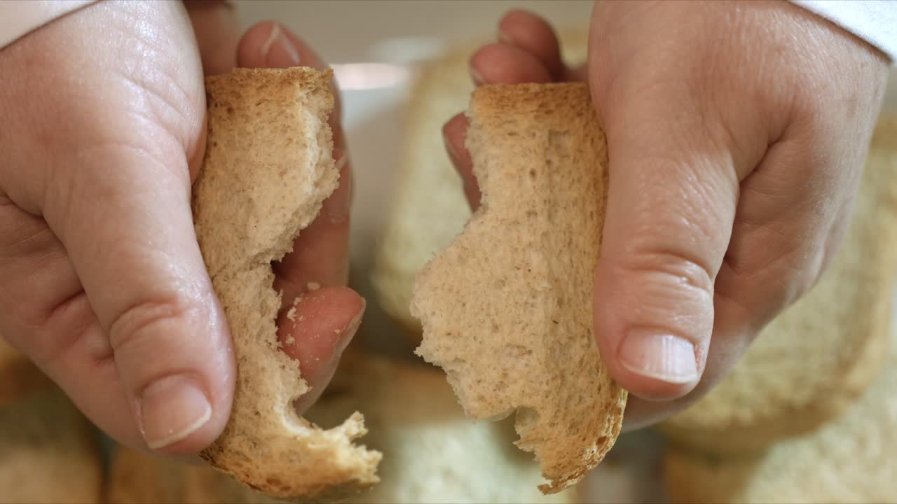 Close up hands breaking toast cracker in half