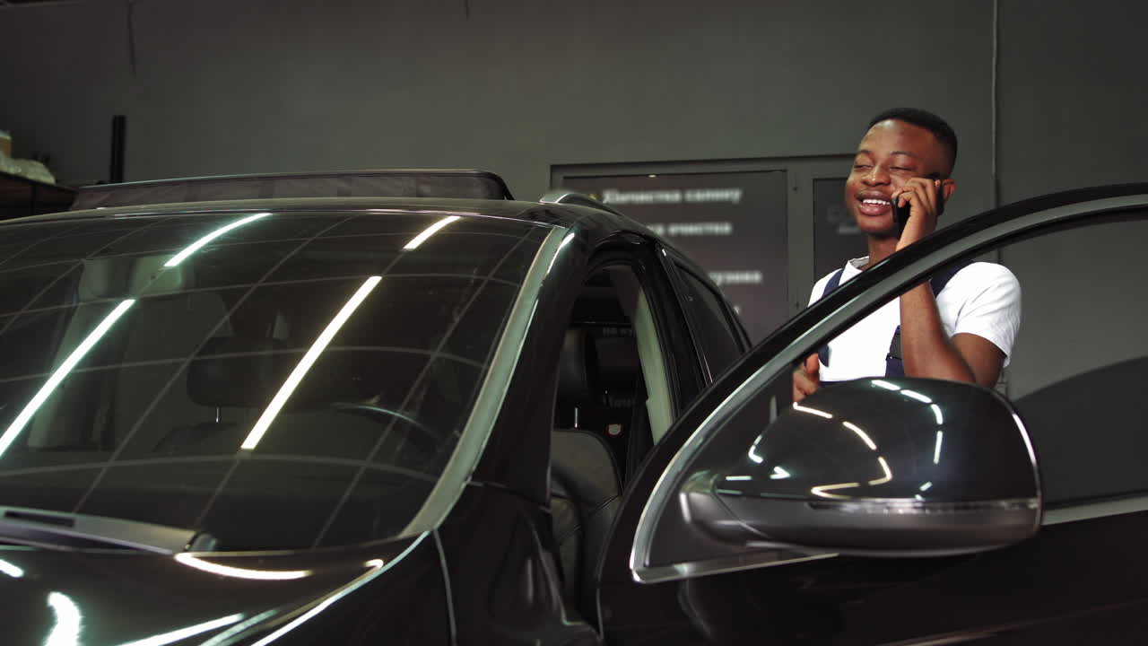 Mechanic Talking on Phone by Car