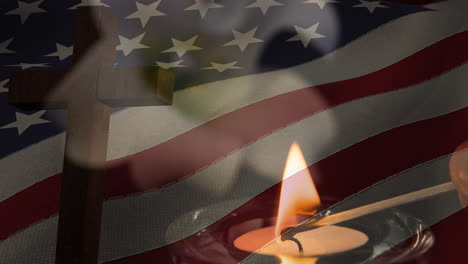 animation of crucifix and candle moving over american flag