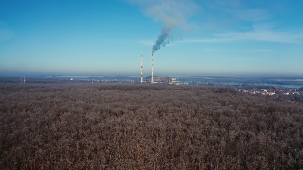 Landscape with smoked polluted atmosphere. Aerial view of high chimney pipes with grey smoke