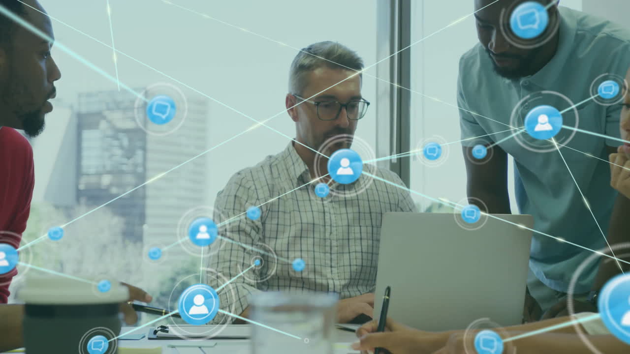 Animation of network of connections with icons over diverse colleagues using laptop in office