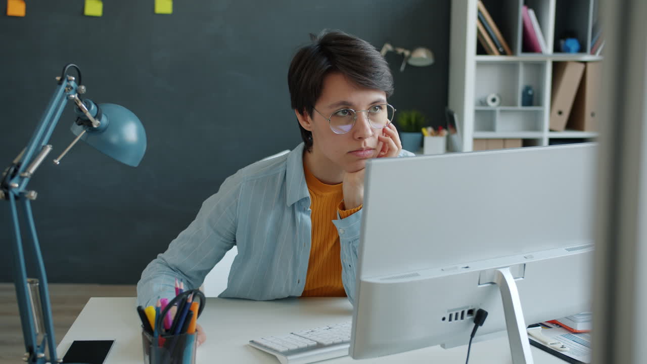 Woman Working at a Computer in an Office