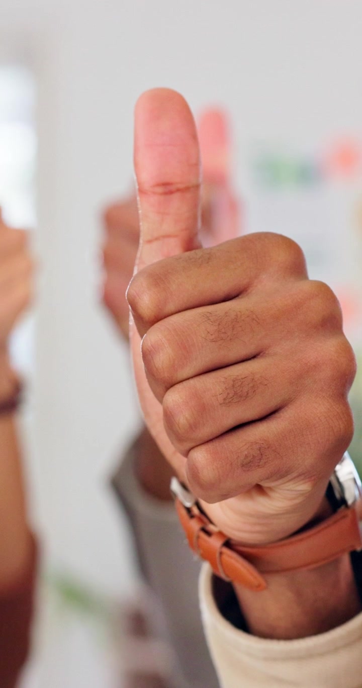 Close-up of Person Giving a Thumbs Up Gesture