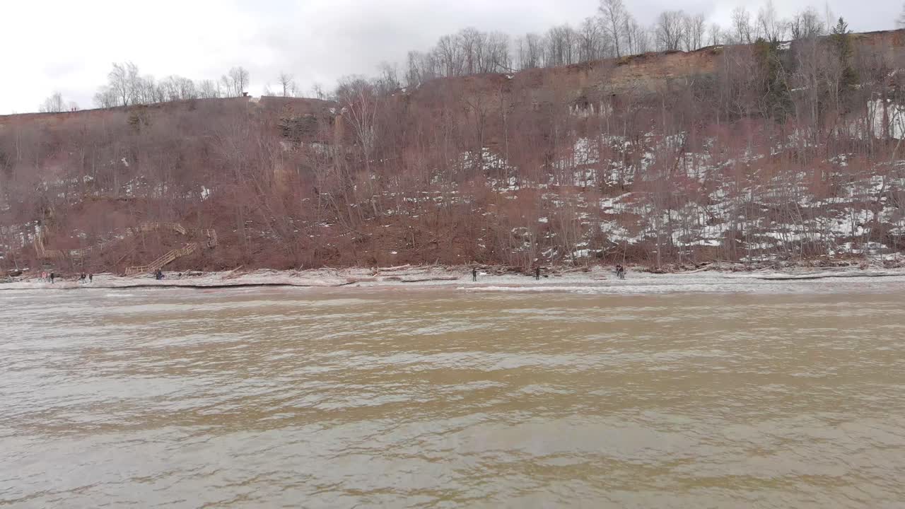 절벽 과 사람 들 이 있는 겨울 해변 장면