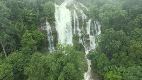 aerial view of cascading wachirathan waterfalls. dolly forward