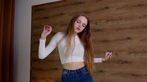 young woman dancing with headphones on