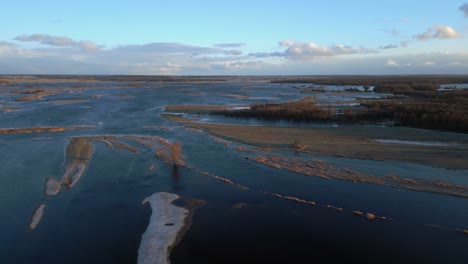 Drone-dolley-tilt-shot-over-the-Narew-river-with-a-single-tree-in-the-water