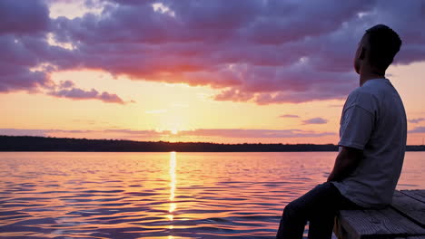 feet dipping in lake water at sunset