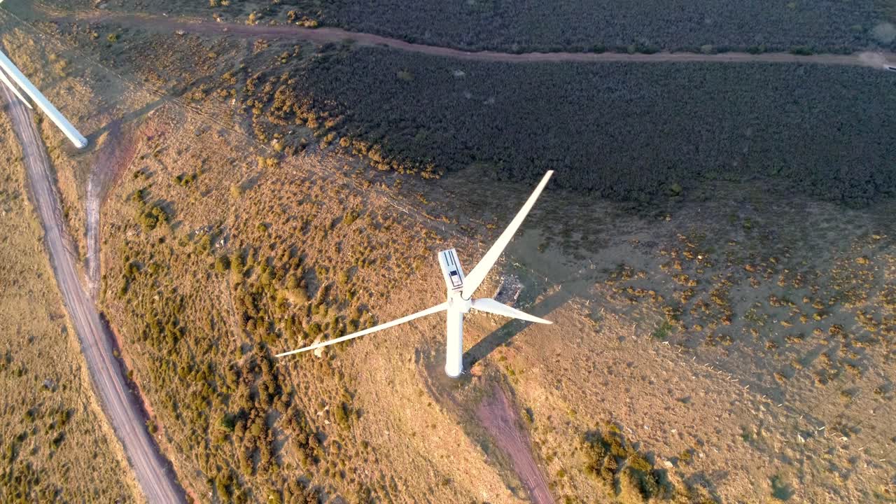 Hoovering over a windmill in the sunset aerial shot