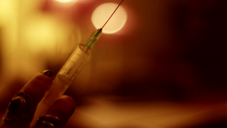 syringe in hand at night