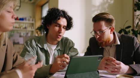 three young professionals in a business meeting, discussing ideas and plans