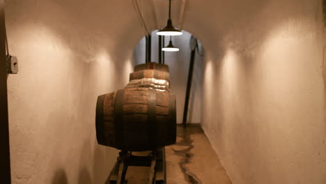 old antique oak barrels and kegs on a rack sliding shot